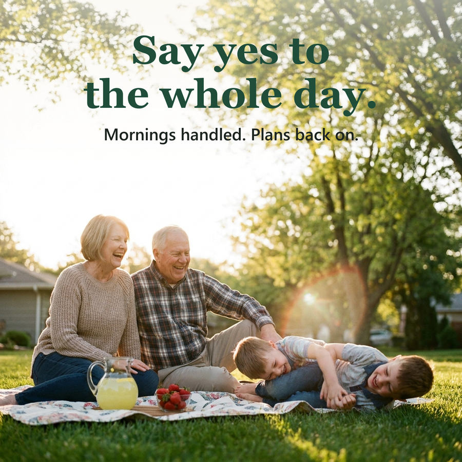 Grandparents laughing with their grandchildren on a picnic blanket in the sun. Say yes to the whole day.